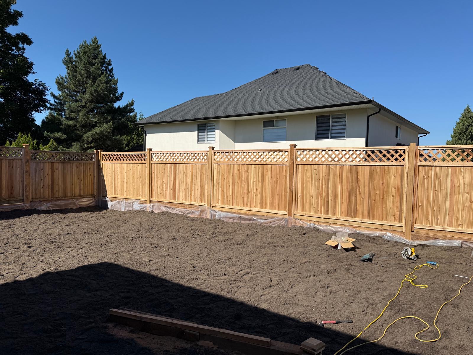 A cedar fence and prepared ground